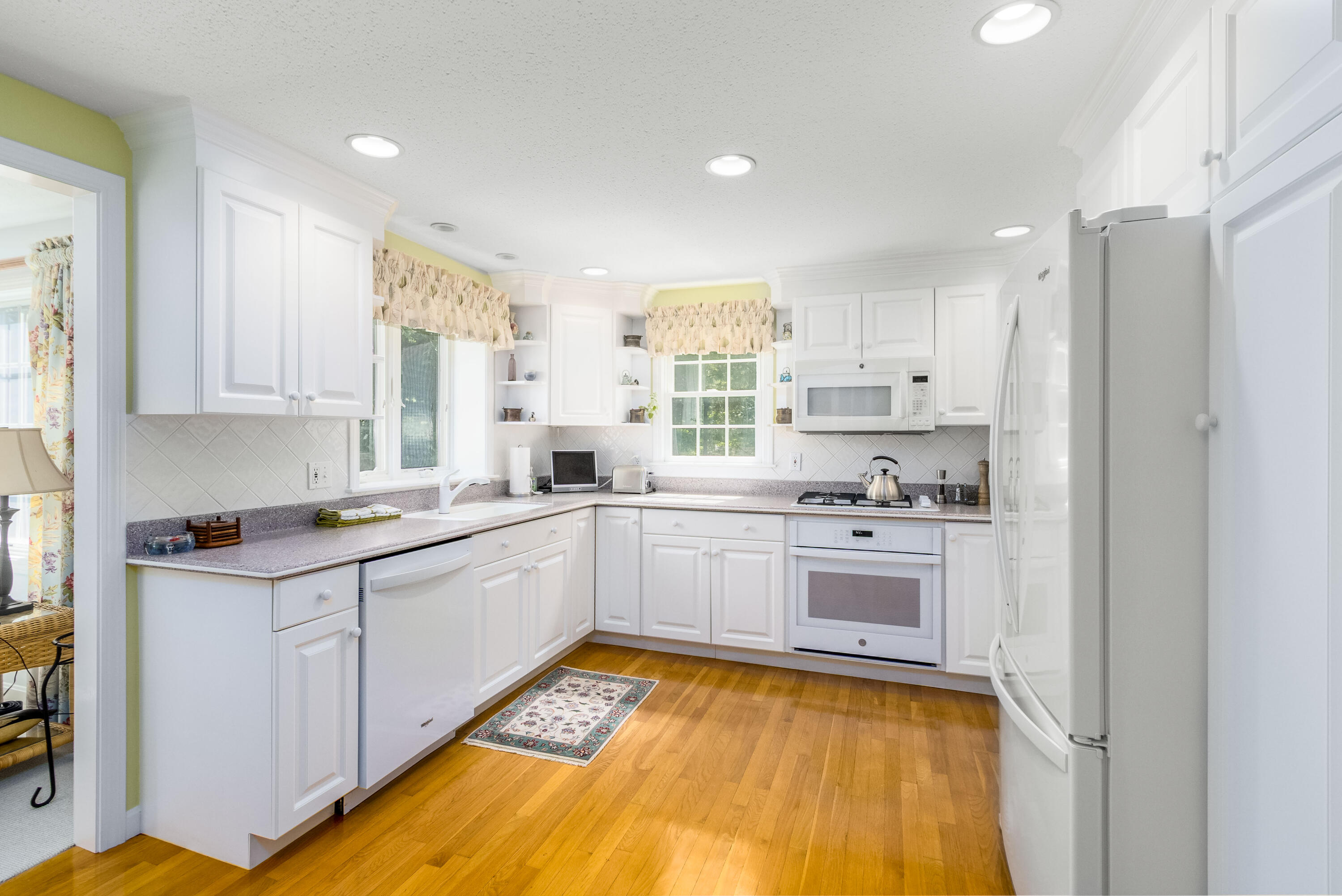 110 Marble Road Barnstable, MA 02630 - Photo 12 of 33 a kitchen with kitchen island granite countertop white cabinets and white appliances