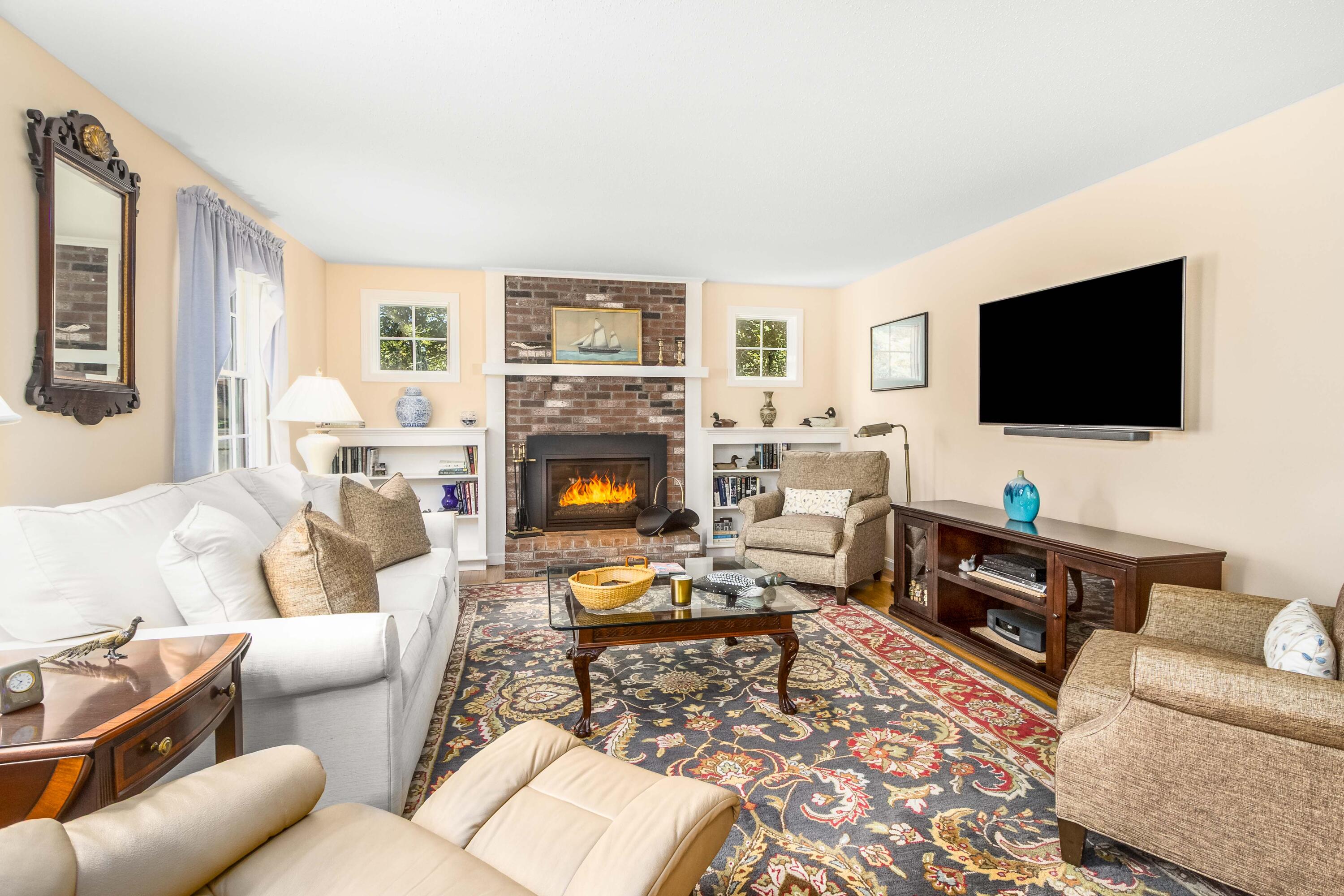 110 Marble Road Barnstable, MA 02630 - Photo 3 of 33 a living room with furniture a flat screen tv and a fireplace
