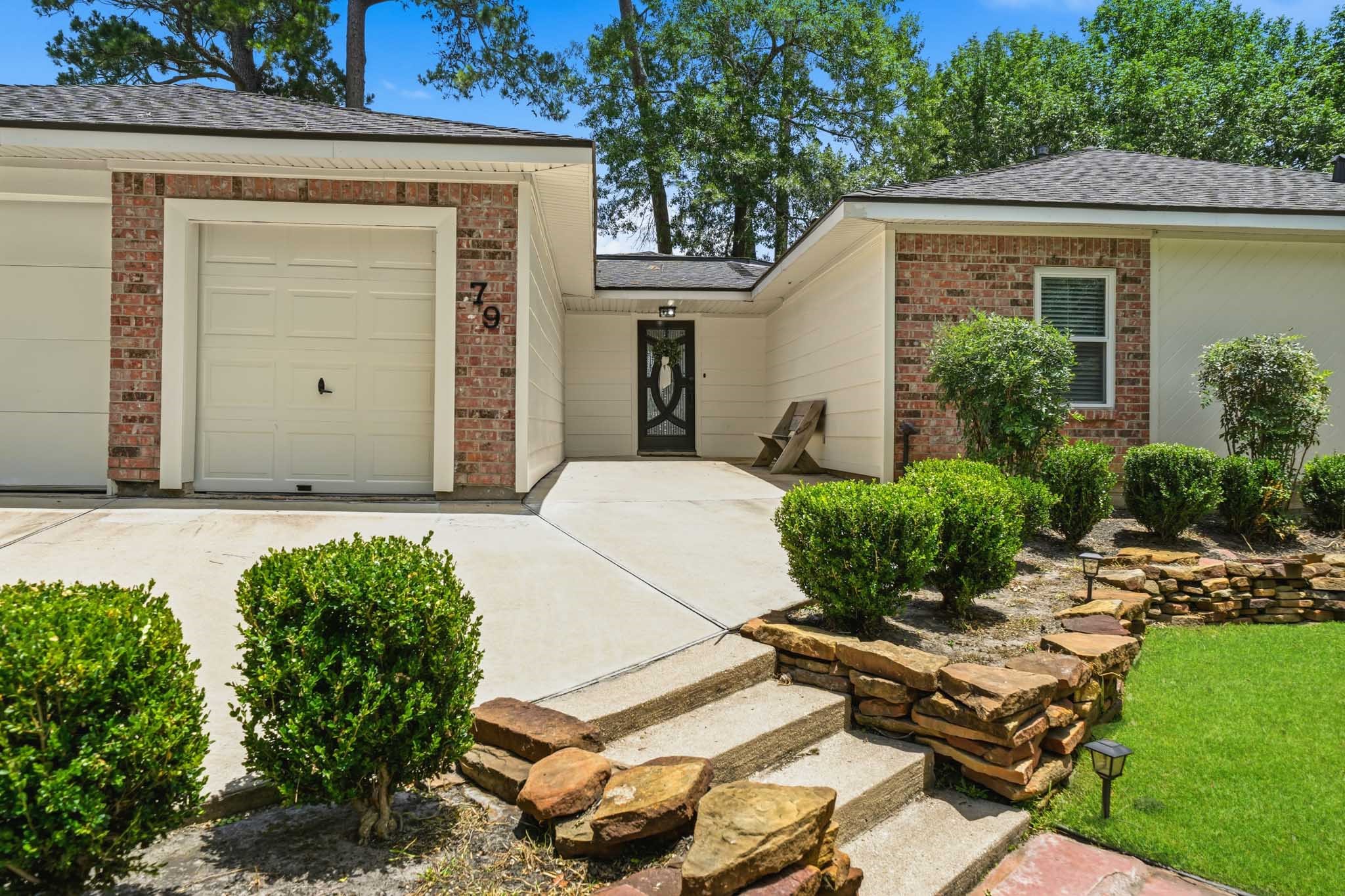 79 Summers Wind Street Conroe, TX 77356 - Photo 2 of 45 a front view of a house with garden
