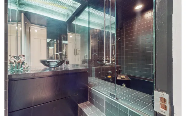 a spacious bedroom with a bed a couch and a window