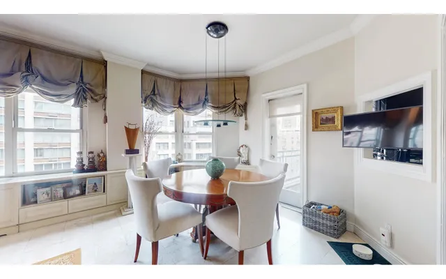 a living room with furniture and a view of kitchen