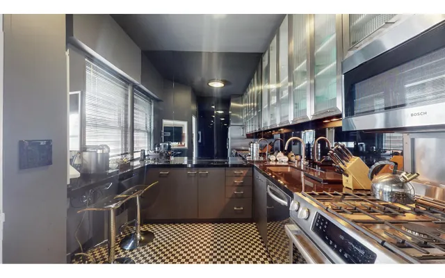 a view of a dining room with furniture a rug and wooden floor