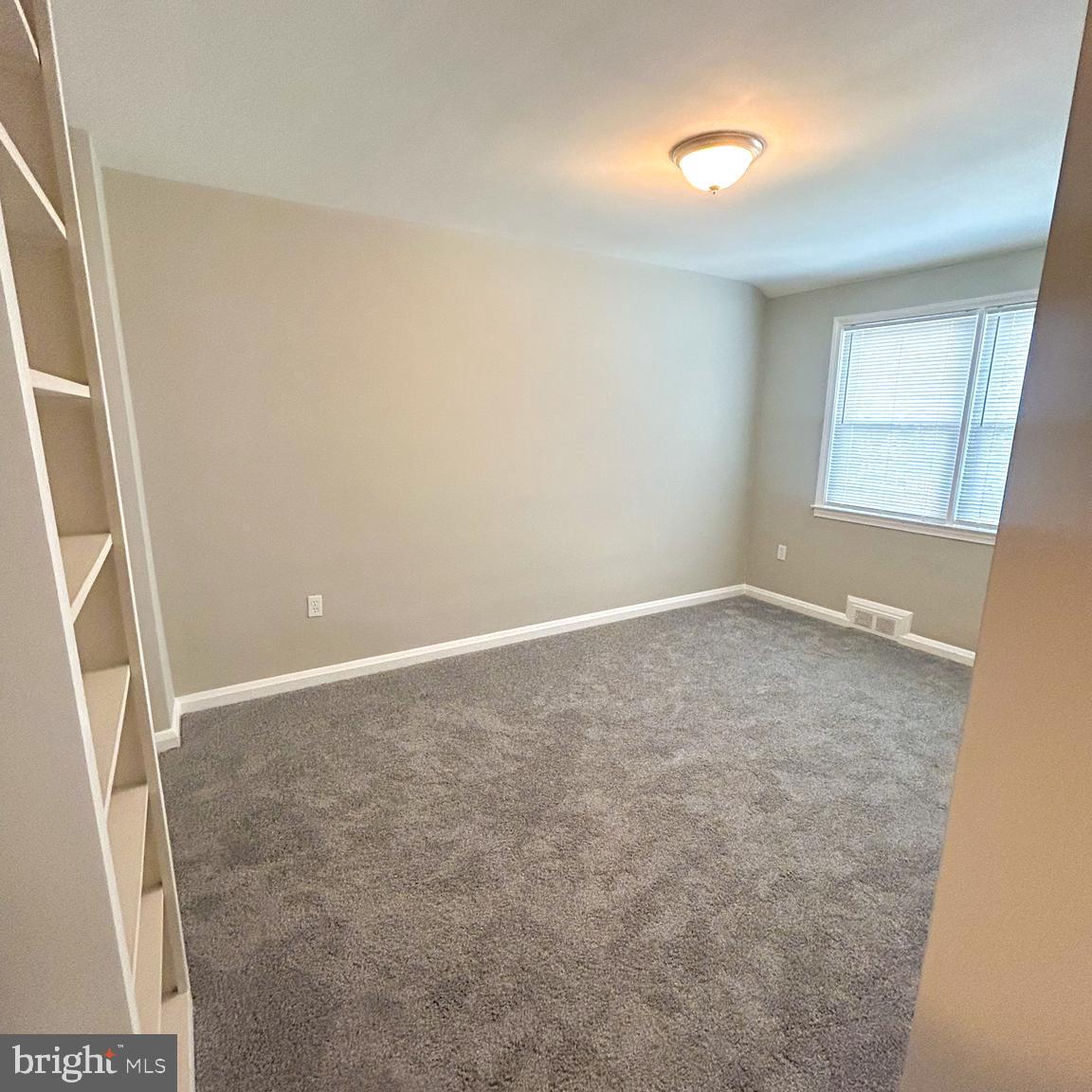 1260 Cedarcroft Road Baltimore, MD 21239 - Photo 13 of 18 an empty room with windows