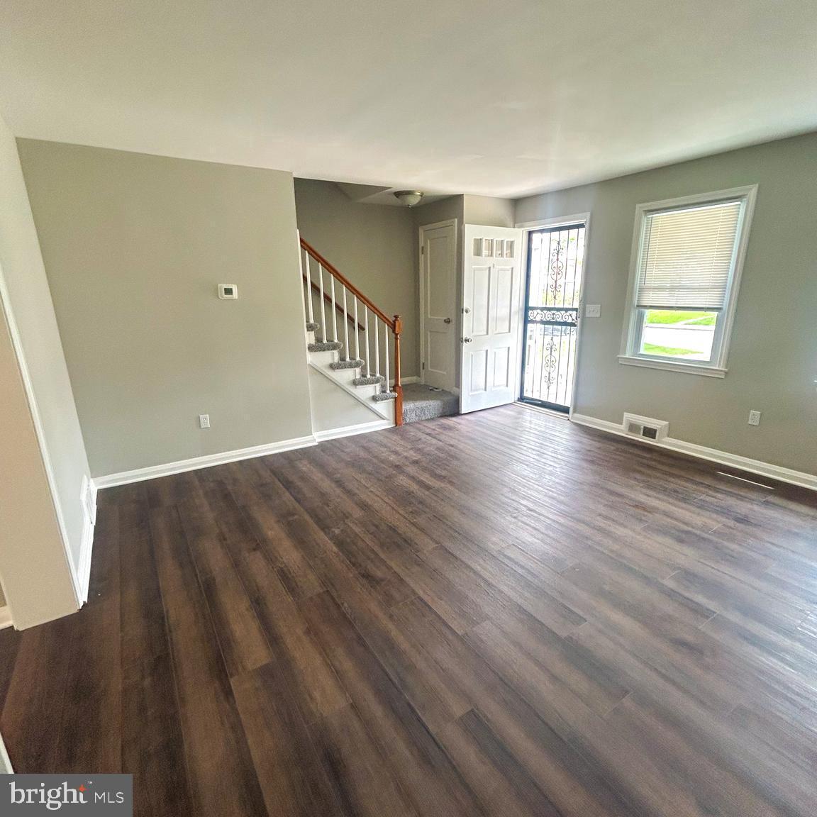 1260 Cedarcroft Road Baltimore, MD 21239 - Photo 18 of 18 a view of an empty room with wooden floor and a window