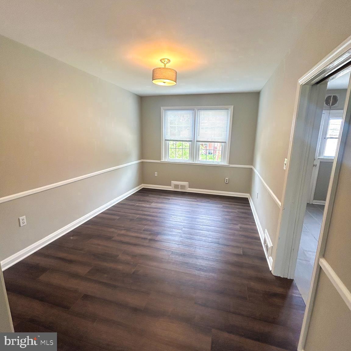 1260 Cedarcroft Road Baltimore, MD 21239 - Photo 4 of 18 a view of empty room with wooden floor and fan
