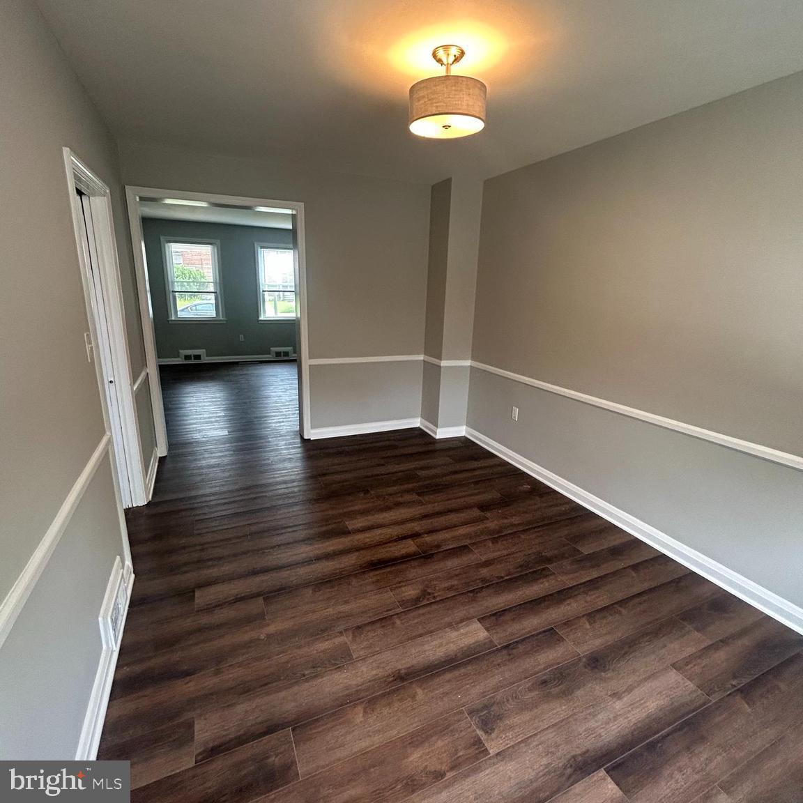 1260 Cedarcroft Road Baltimore, MD 21239 - Photo 5 of 18 wooden floor in an empty room with a window