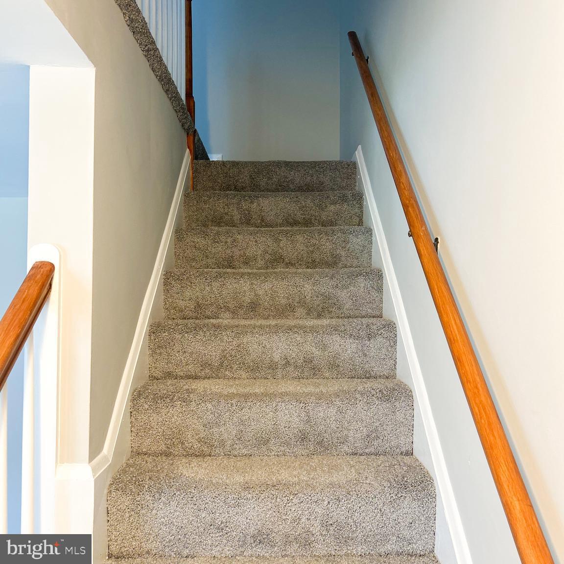 1260 Cedarcroft Road Baltimore, MD 21239 - Photo 7 of 18 a view of staircase with white walls and stairs