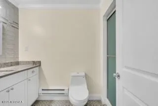 a bathroom with a toilet a sink and mirror