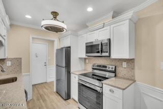 204 Covered Bridge Boulevard, Unit D Manalapan, NJ 07726 - Photo 5 of 20 a kitchen with stainless steel appliances granite countertop a refrigerator and a stove top oven