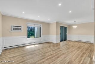204 Covered Bridge Boulevard, Unit D Manalapan, NJ 07726 - Photo 9 of 20 a view of an empty room with wooden floor and a window