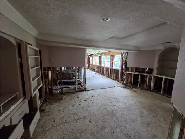 a kitchen with granite countertop a sink and a stove