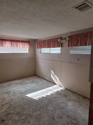 a view of a hallway with workspace and closet area