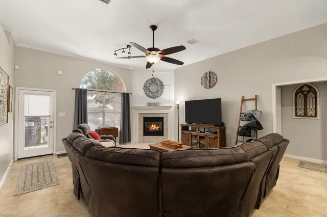 a living room with furniture a large window and a fireplace