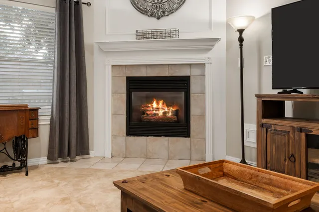 a living room with a fireplace and a flat screen tv