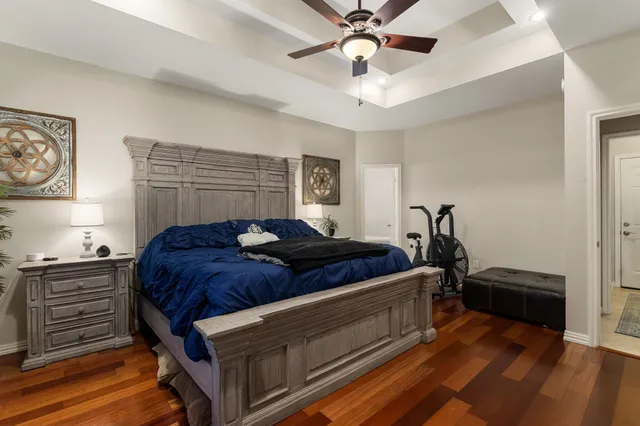 a bedroom with a bed and a chandelier