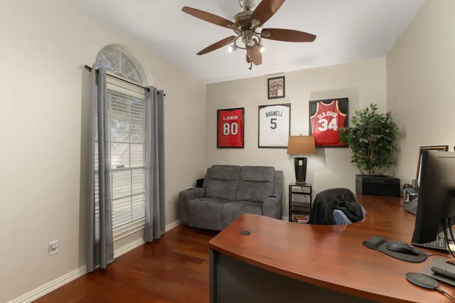 a work room with furniture and wooden floor