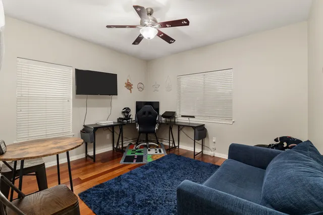 a livingroom with workspace and a couch