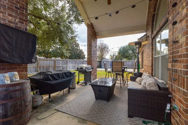 a outdoor living space with patio furniture and a fireplace