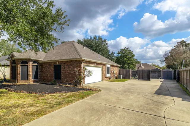 a front view of a house with a yard and trees