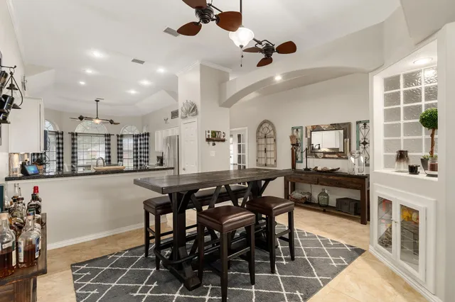 a view of a dining room with furniture and a kitchen view