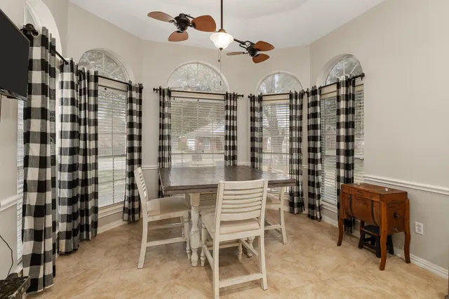 a view of a dining room with furniture and chandelier