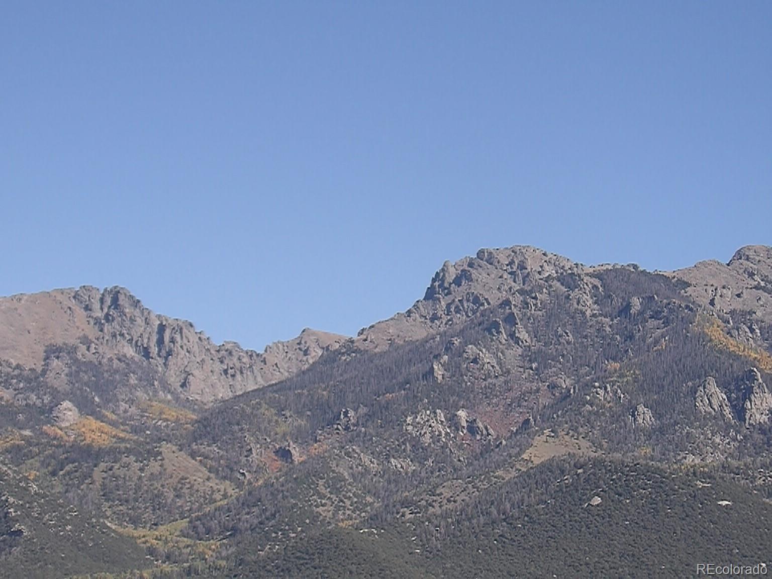 837 Pine Cone Road Crestone, CO 81131 - Photo 6 of 7 a view of a large mountain with trees in the background