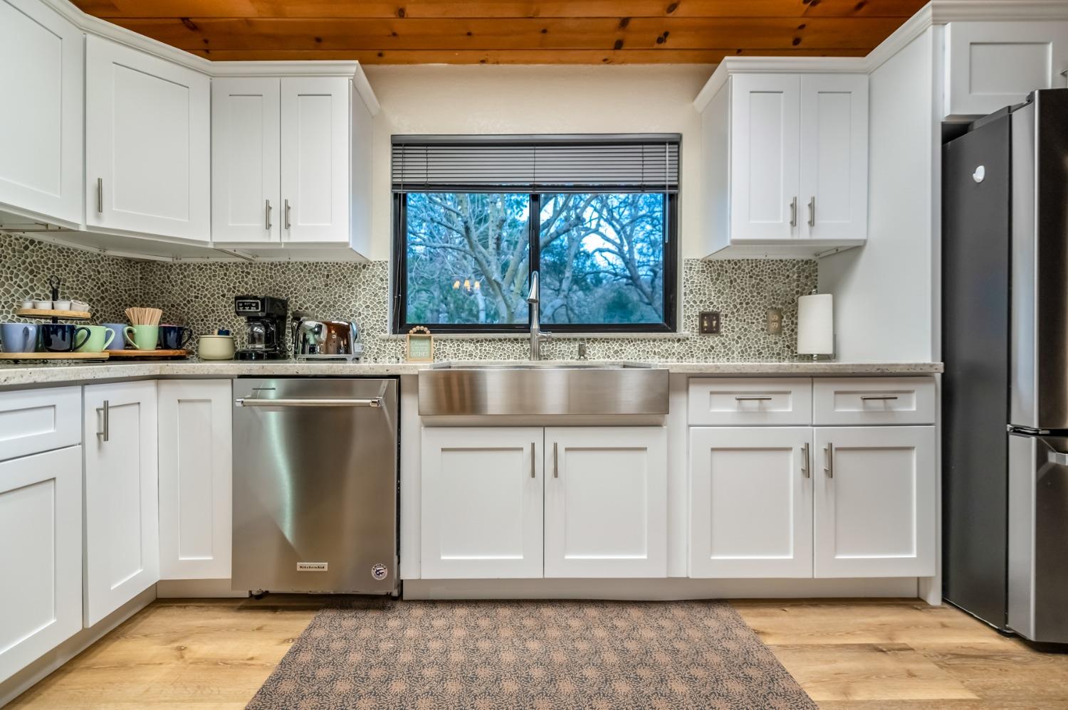 40984 Grouse Drive Three Rivers, CA 93271 - Photo 11 of 49 a kitchen with white cabinets and window