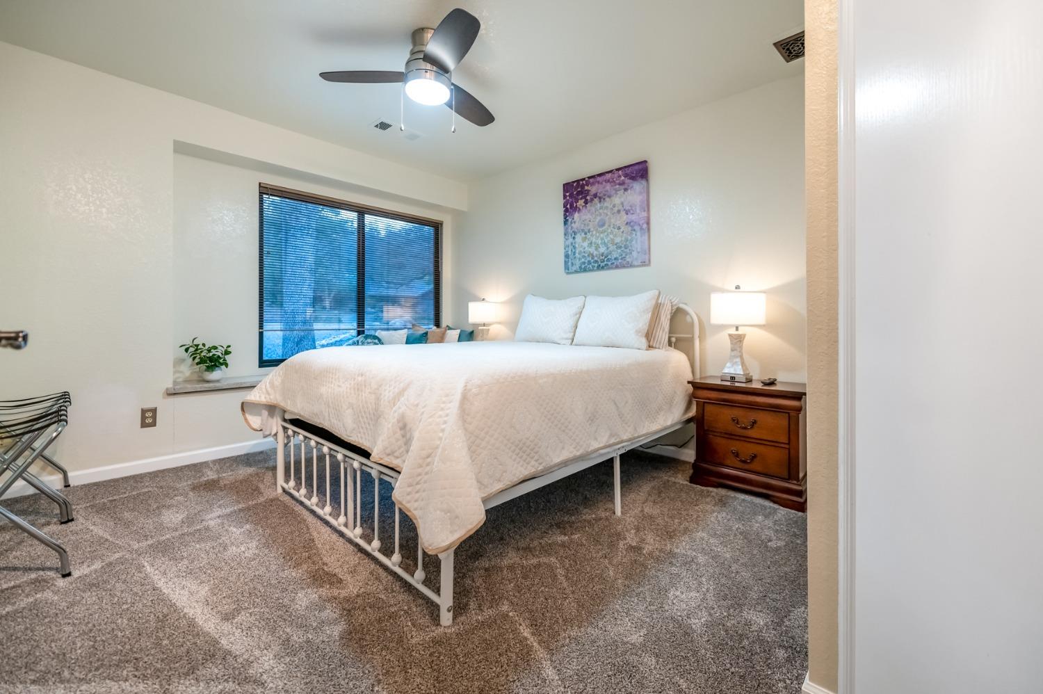 40984 Grouse Drive Three Rivers, CA 93271 - Photo 17 of 49 a bedroom with a bed and a chandelier