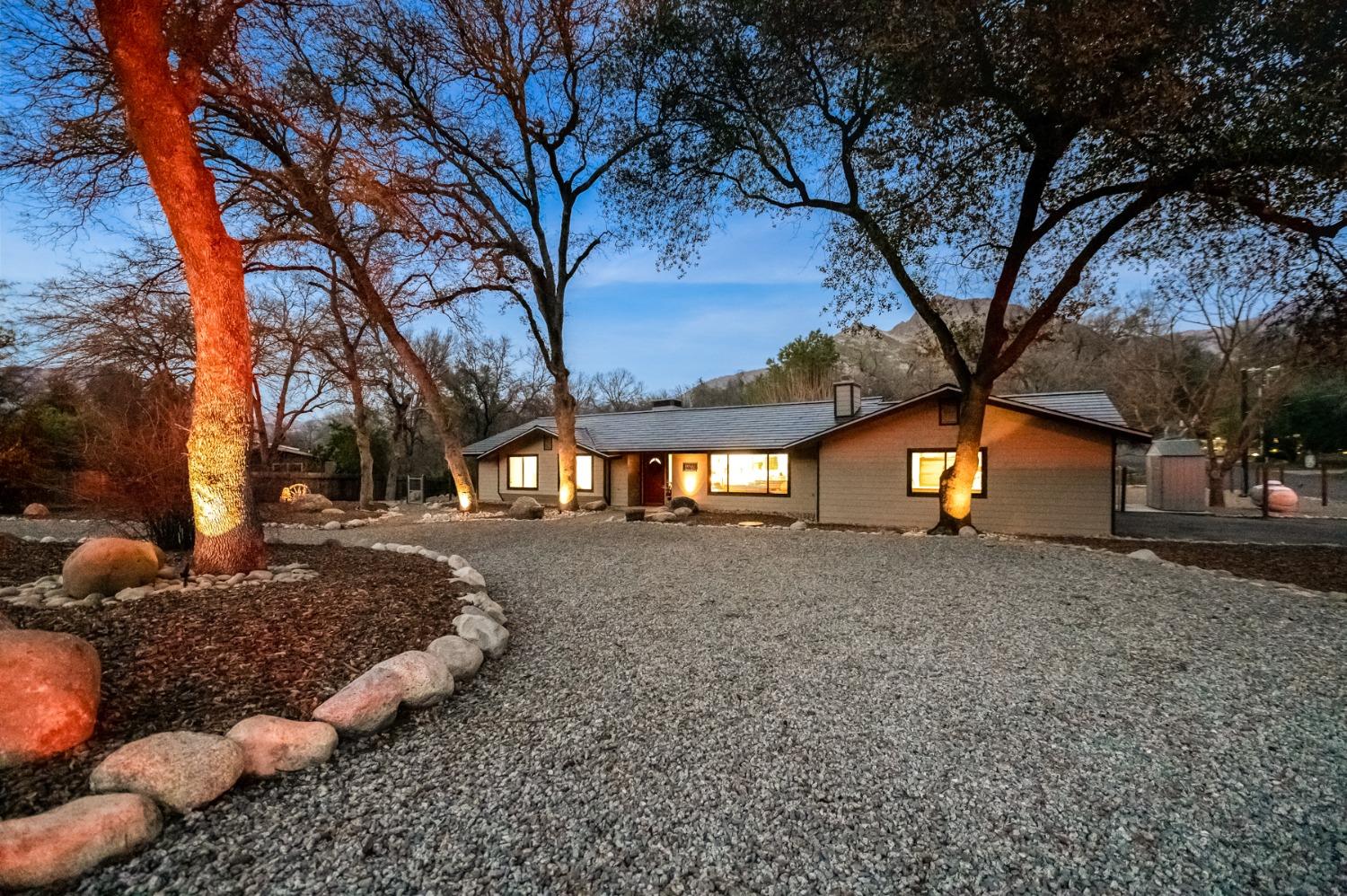 40984 Grouse Drive Three Rivers, CA 93271 - Photo 2 of 49 a front view of a house with a yard covered with snow and trees