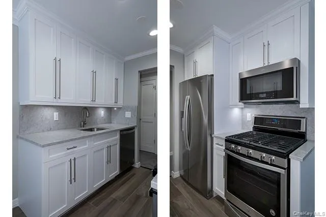 a kitchen with stainless steel appliances a stove a sink and white cabinets