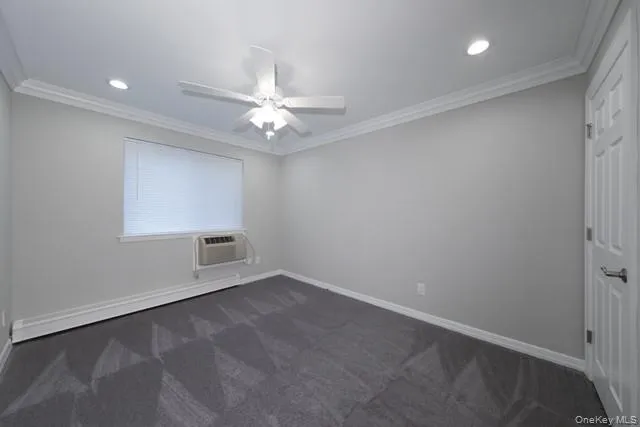 an empty room with a ceiling fan and a window