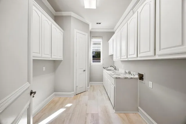 a spacious bedroom with a bed and a chandelier