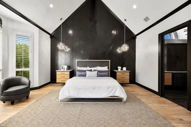 a living room with a bed furniture and a flat screen tv