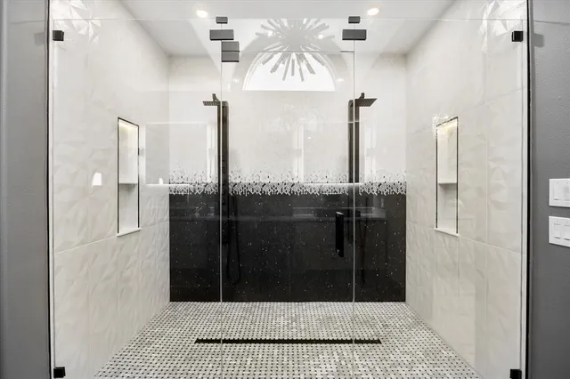 a bathroom with a granite countertop sink a toilet and shower