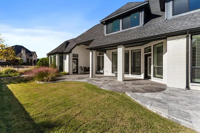 a view of a patio with table and chairs with wooden floor and fence