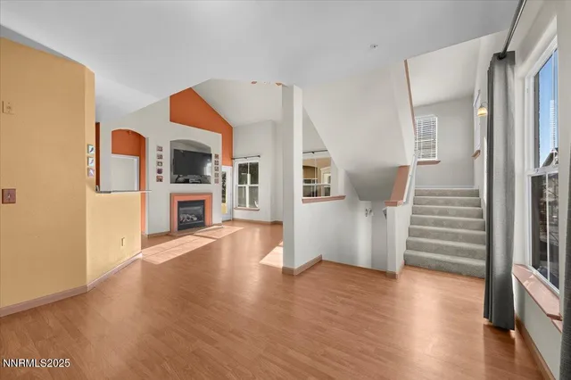 a view of a living room with furniture and wooden floor