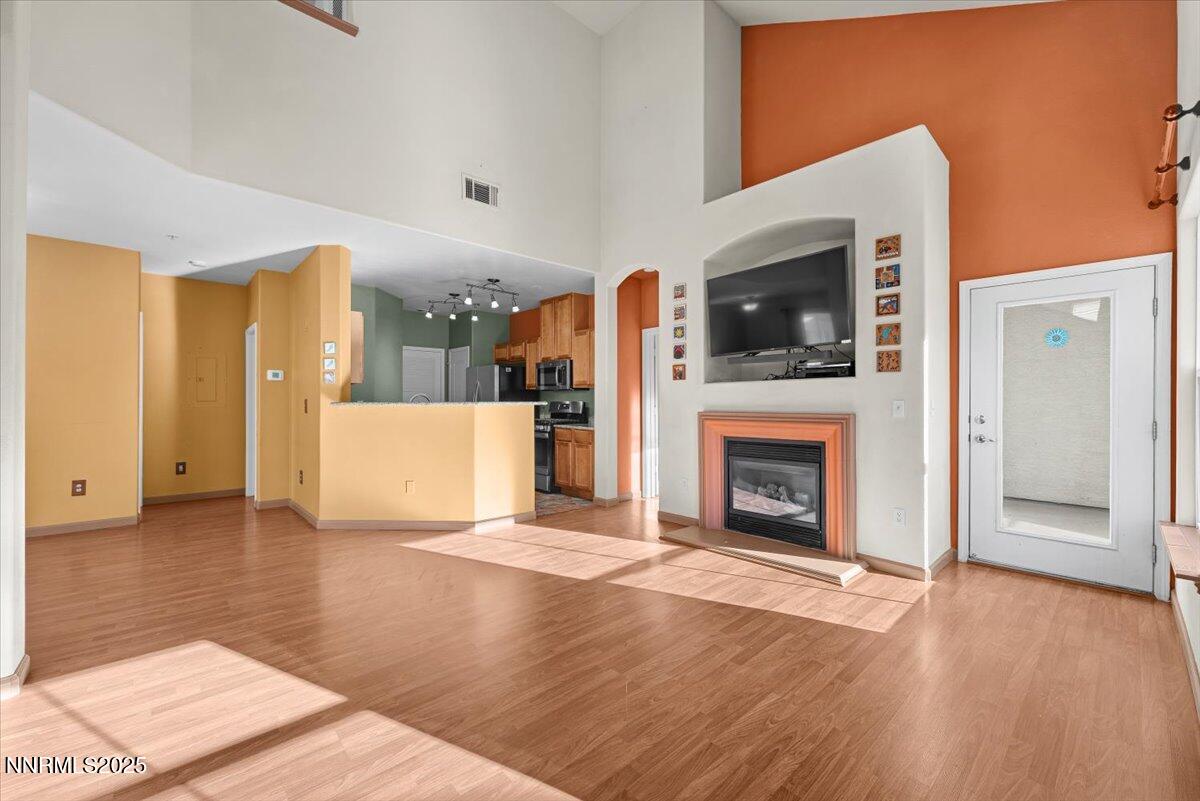 9050 Double R Boulevard, Unit 821 Reno, NV 89521 - Photo 4 of 20 a view of a livingroom with a fireplace cabinet and windows