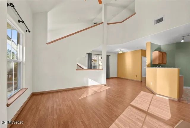 a view of a kitchen with wooden floor and a refrigerator