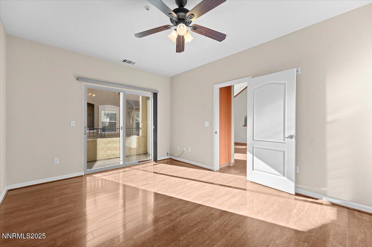 9050 Double R Boulevard, Unit 821 Reno, NV 89521 - Photo 10 of 20 a view of an empty room with window and wooden floor