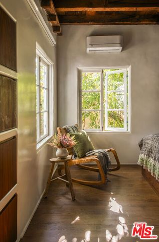 a bed sitting in a bedroom next to a window