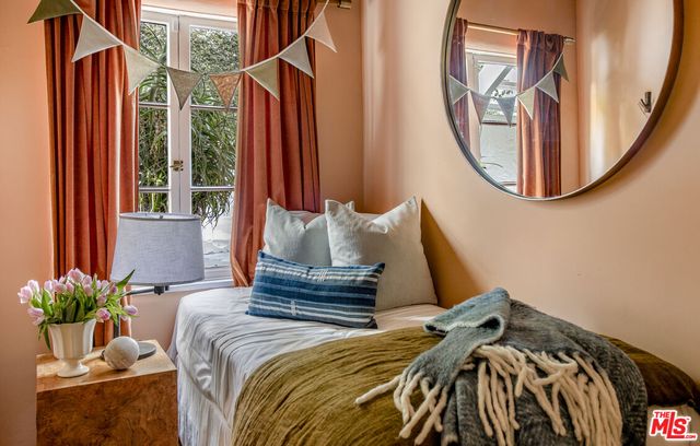 a bedroom with a bed and a mirror