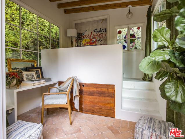 a view of a room with a bed and a window