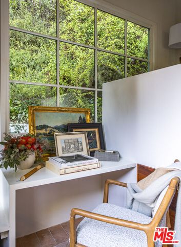 a bedroom with two beds and a window