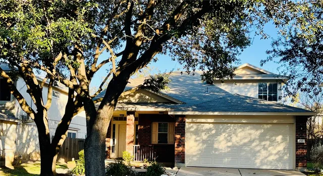 a view of a house with a tree