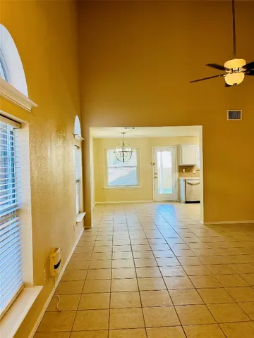 a view of a big room with wooden floor and a door