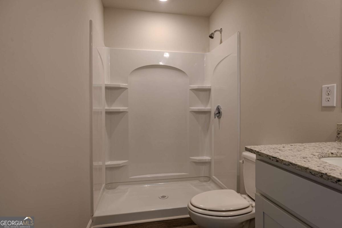 23 Sweetspire Drive Northwest Rome, GA 30165 - Photo 12 of 23 a bathroom with a granite countertop bathtub shower sink vanity and toilet