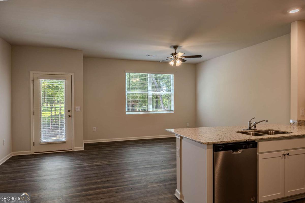 23 Sweetspire Drive Northwest Rome, GA 30165 - Photo 13 of 23 an empty room with wooden floor a ceiling fan and a window
