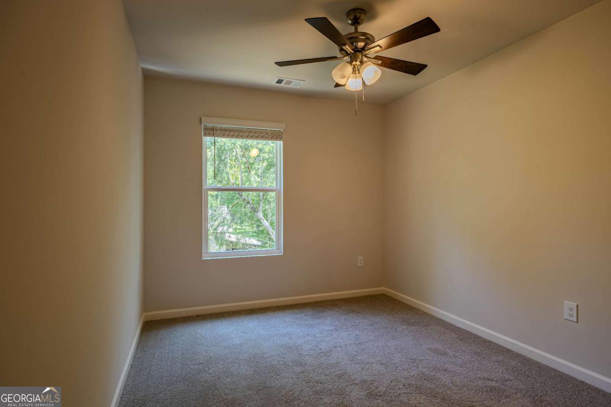23 Sweetspire Drive Northwest Rome, GA 30165 - Photo 5 of 23 an empty room with a window and a fan