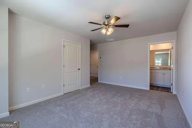 a view of an empty room and closet area