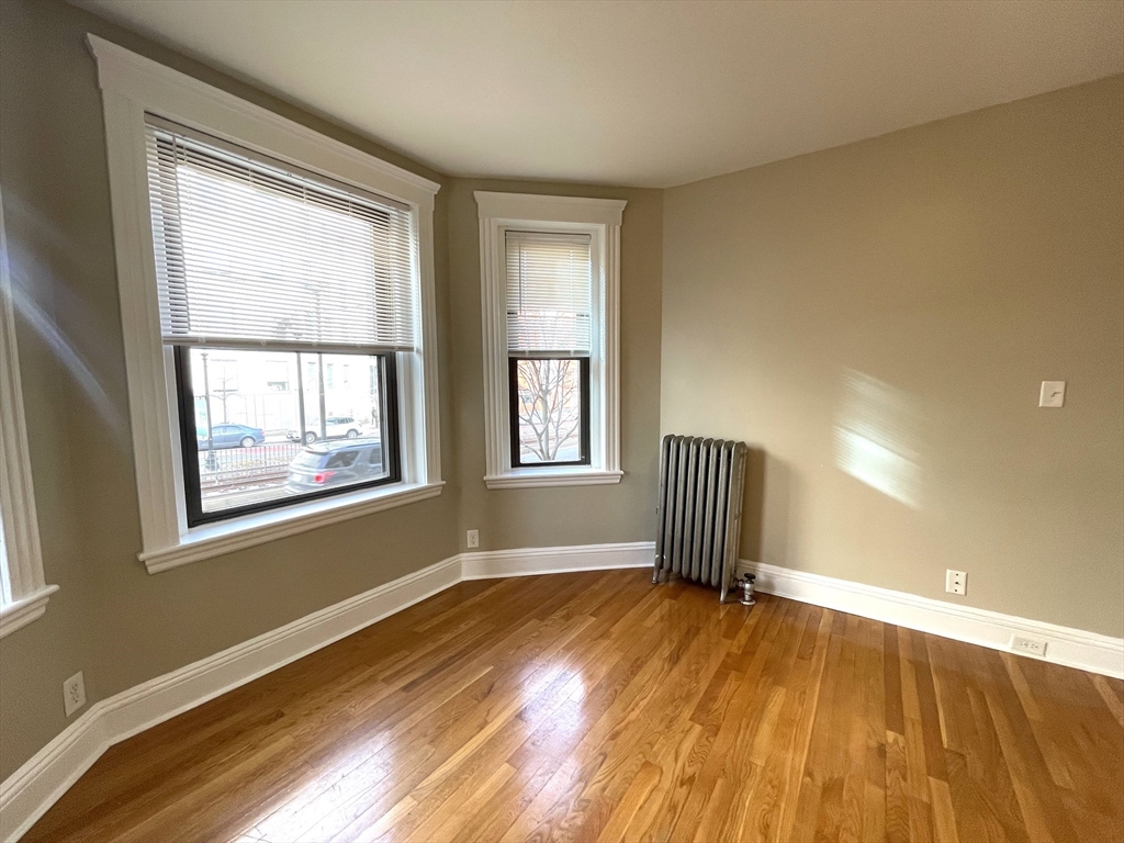 660 Huntington Avenue, Unit 14 Boston, MA 02115 - Photo 2 of 19 a view of empty room with wooden floor and fan
